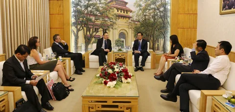 Delegates seated around a table during the cooperation meeting.
