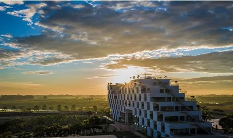 FPT building at Hoa Lac Hi-tech Park beneath an evening sky.