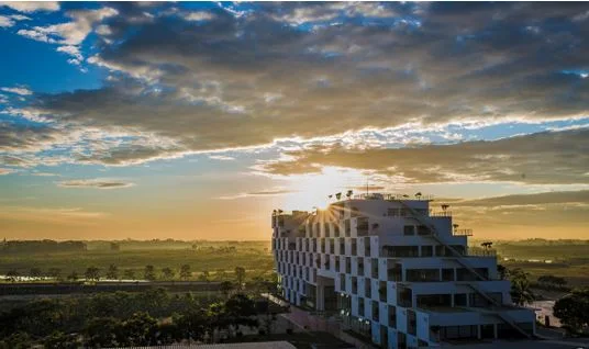 FPT building at Hoa Lac Hi-tech Park beneath an evening sky.