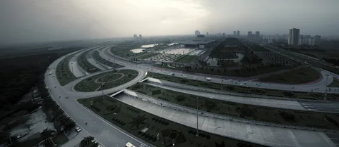 Hoa Lac Highway curves through an interchange with buildings in the distance.